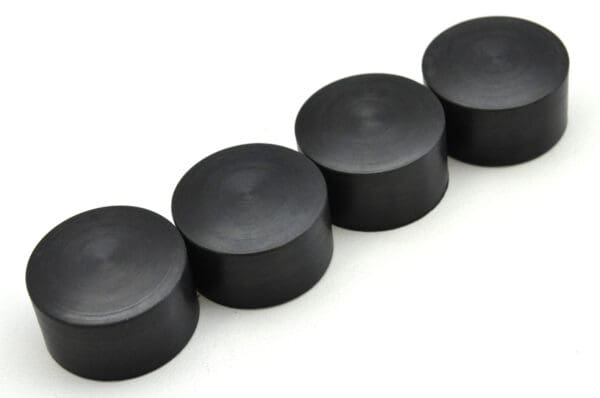 A row of black round magnets lined up in a line.