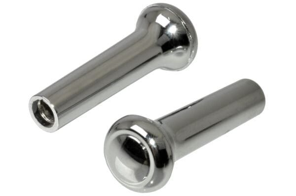 A pair of metal knobs with one holding the other.