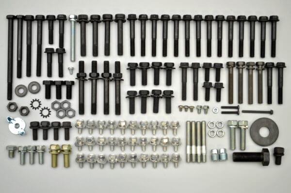 A large assortment of hardware is shown on the table.