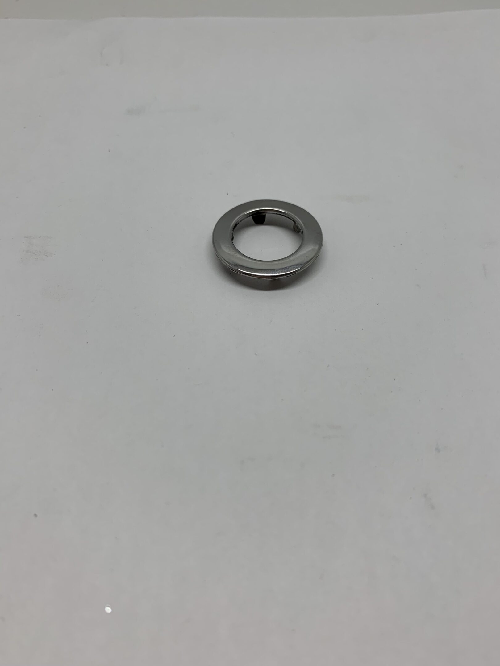 A metal ring sitting on top of a white table.