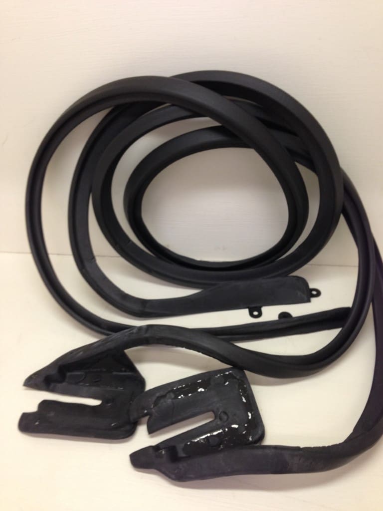 A black rubber seal with two clips and one piece.