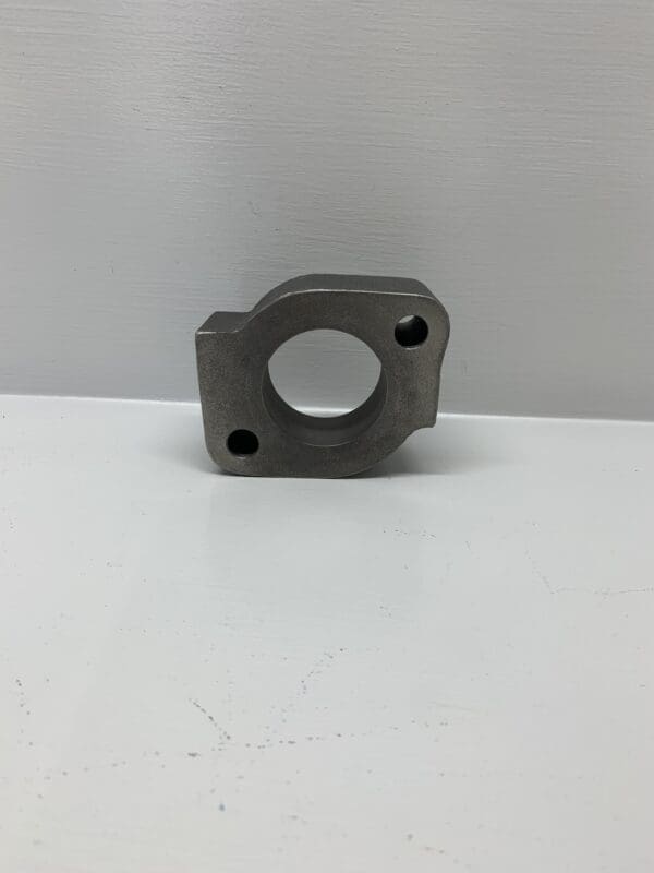 A metal part sitting on top of a table.