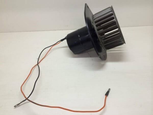 A black fan with wires attached to it.