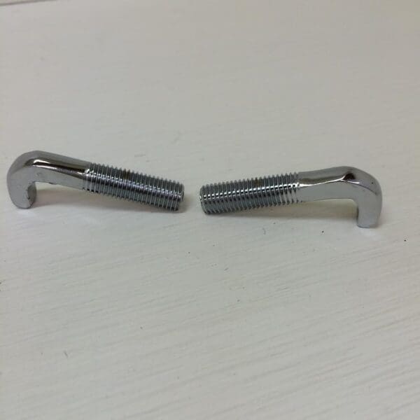 A pair of metal clips sitting on top of a table.