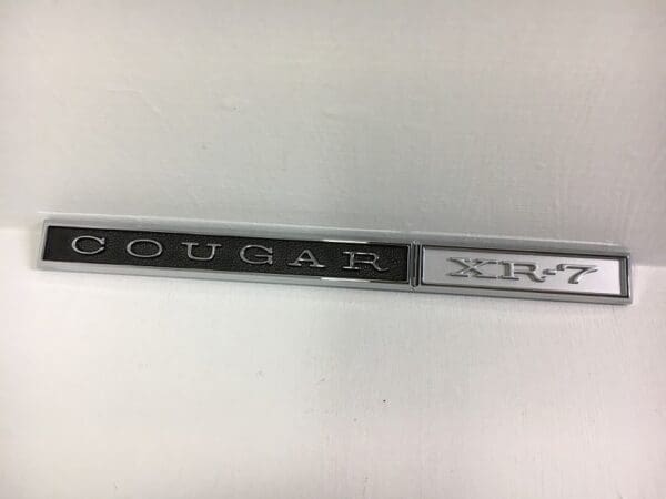 A close up of the word cougar on a stick