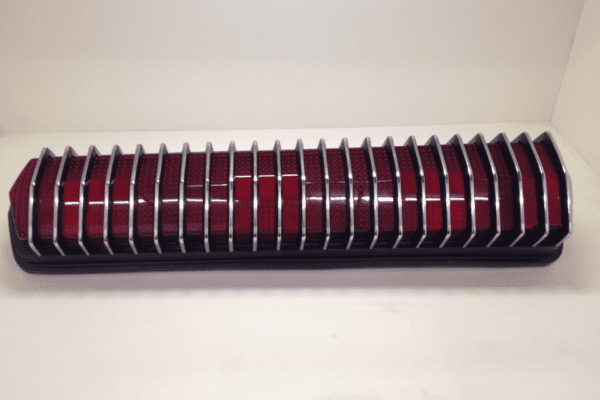 A red and black radiator sitting on top of a white floor.