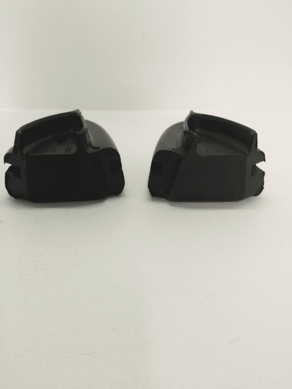 A pair of black plastic shoes on top of a table.