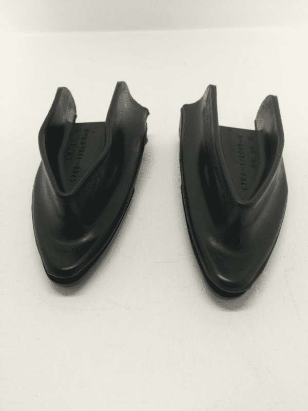 A pair of black shoes on top of a white surface.