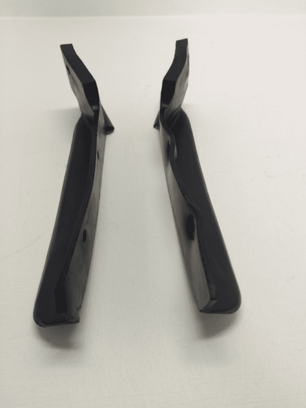 A pair of black plastic handles on top of a table.