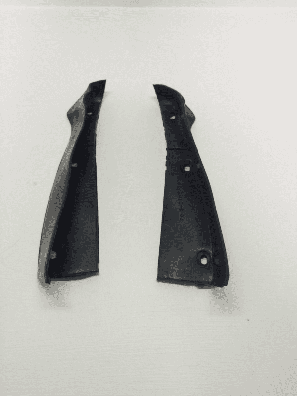 A pair of black plastic handles on a white background.