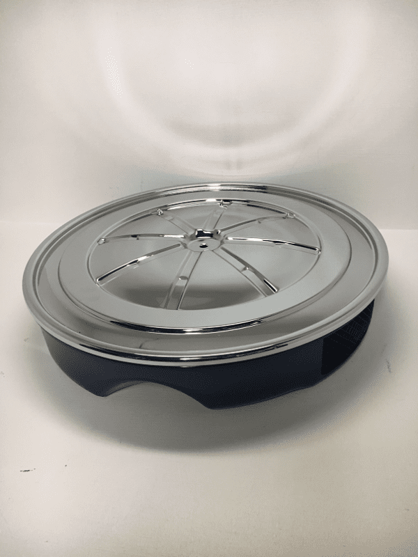 A silver and black dish on top of a table.