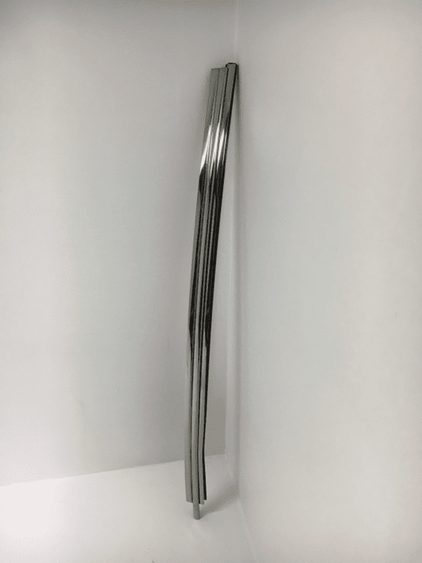 A metal pole in the corner of a room.