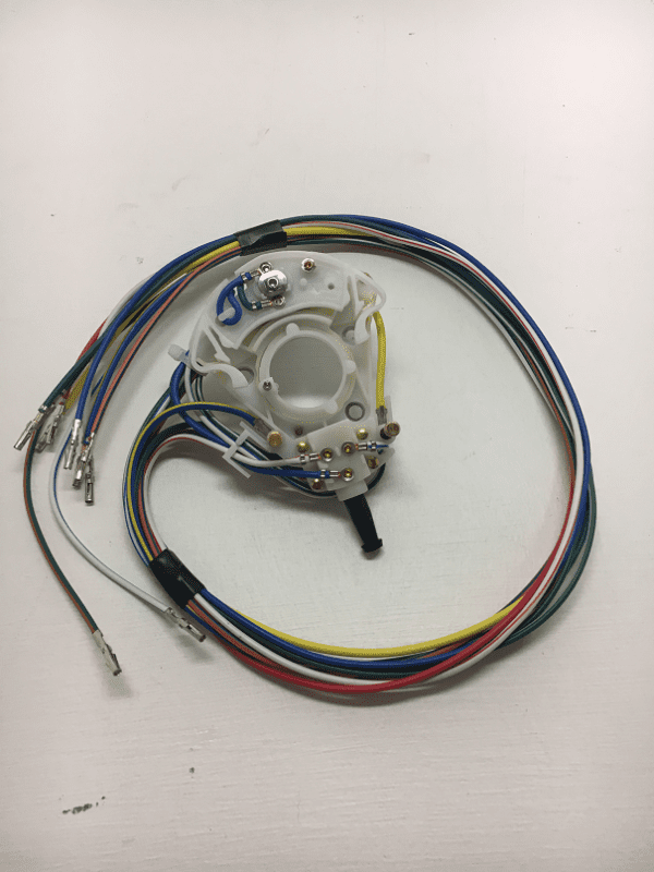 A white clock with wires around it