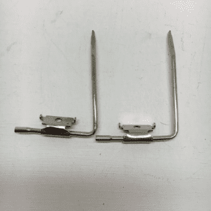 A pair of metal hooks with one holding something.