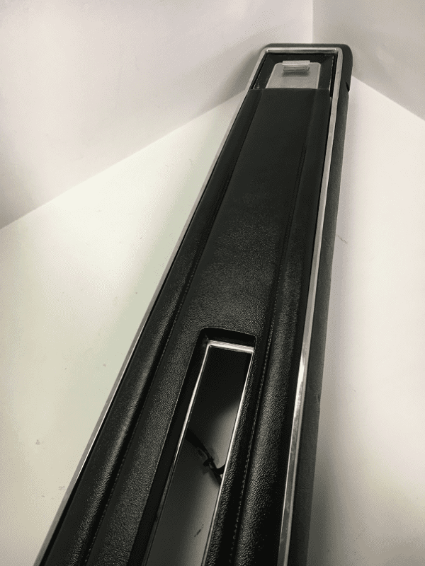 A black and white photo of the top of a door.