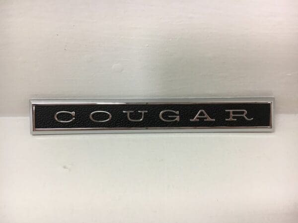 A close up of the word cougar on a stick