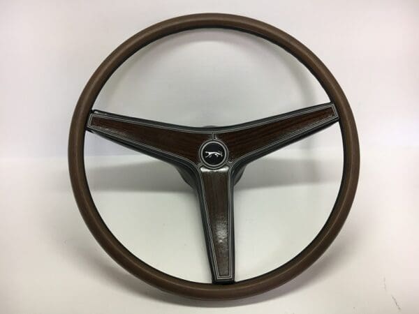 A steering wheel with brown leather and chrome.