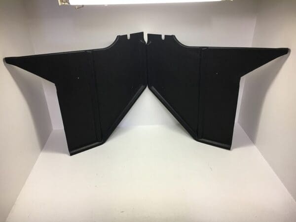 A pair of black panels sitting on top of a table.