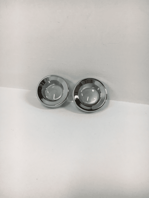 A pair of silver rings sitting on top of a counter.