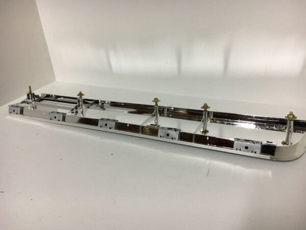 A chrome plated rail with four metal rails.