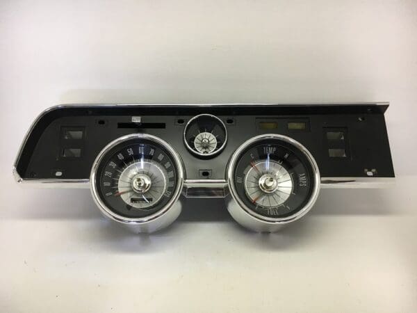 A car dashboard with two different colored gauges.