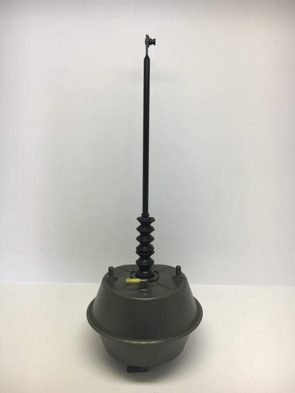 A black rod sitting on top of a metal object.