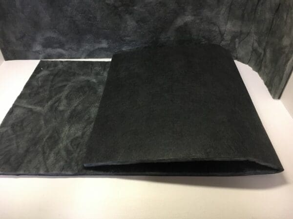 A black piece of paper sitting on top of a table.