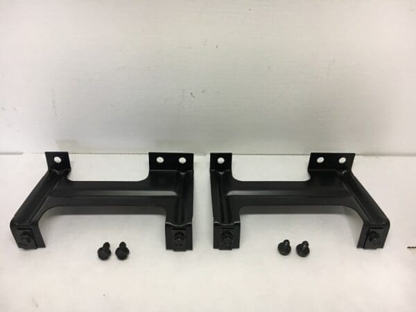 A pair of black metal brackets with some bolts.