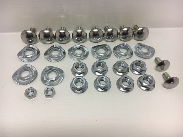 A group of nuts and bolts on top of a table.