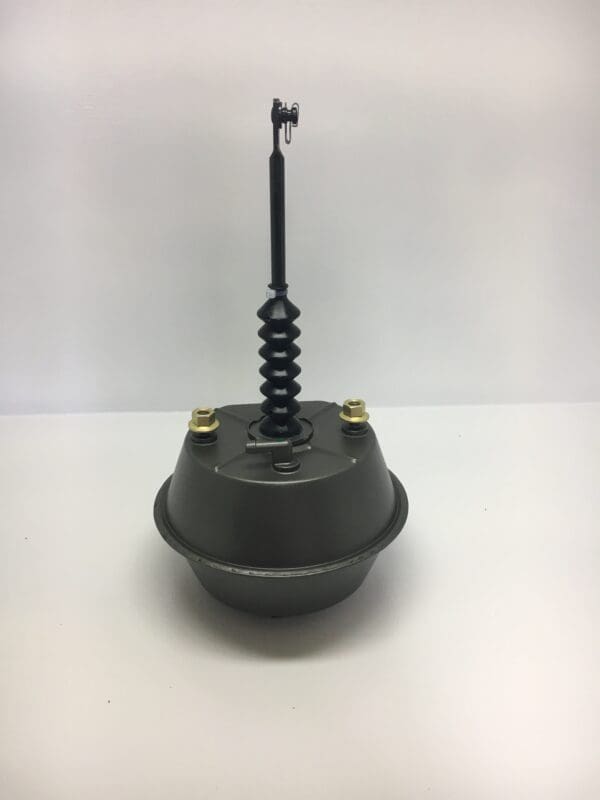 A black metal object with a spring on top of it.