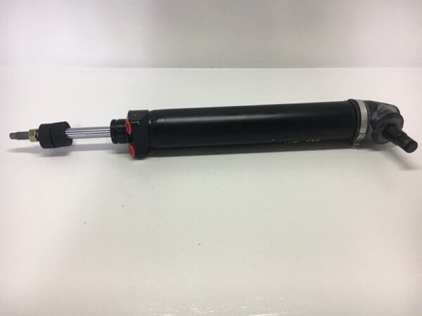 A black and red car shock absorber on top of a table.