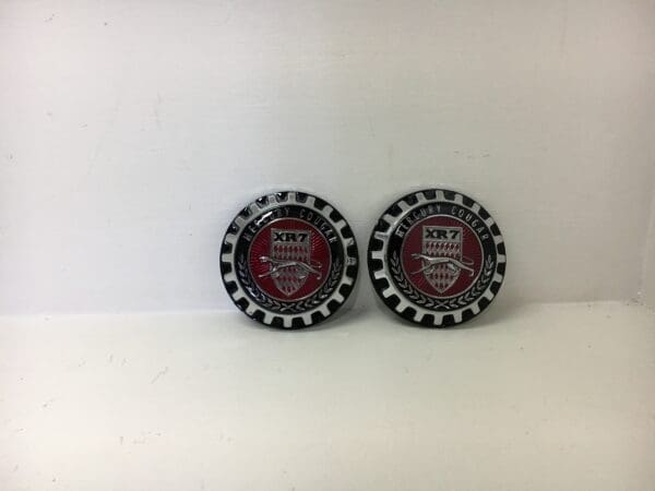 A pair of bottle caps with the words " red and black " on them.