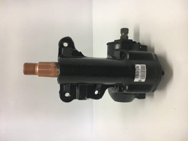 A black motor with copper pipe attached to it.