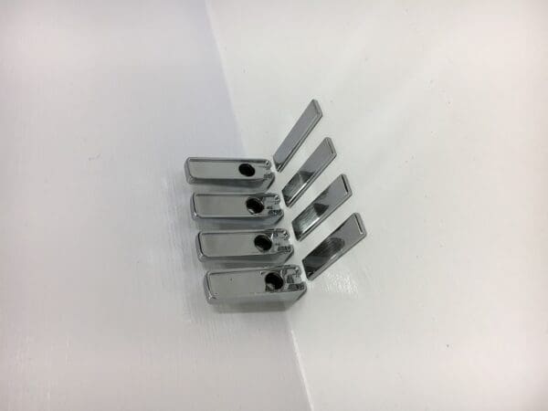 A group of four metal clips on top of each other.