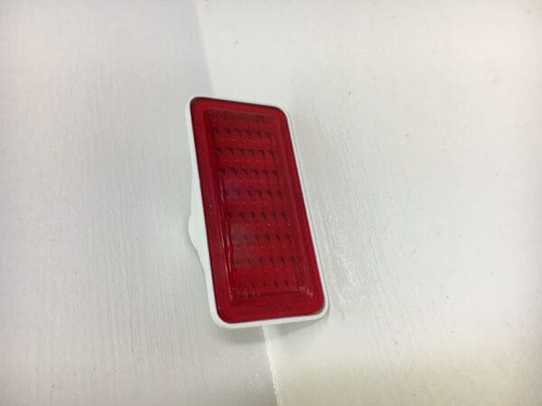 A red and white object sitting on top of a table.