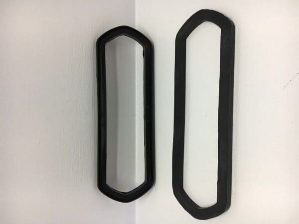 A pair of black mirrors hanging on the wall.