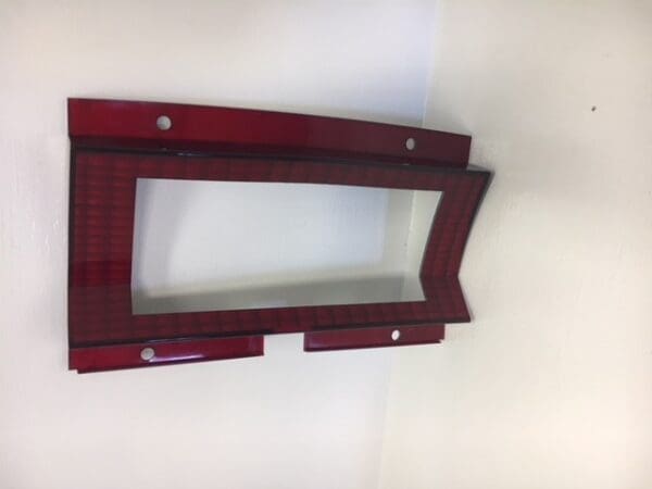 A red wooden frame hanging on the wall.