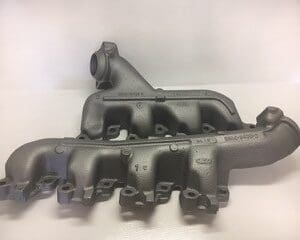 A pair of old cast iron exhaust manifolds.