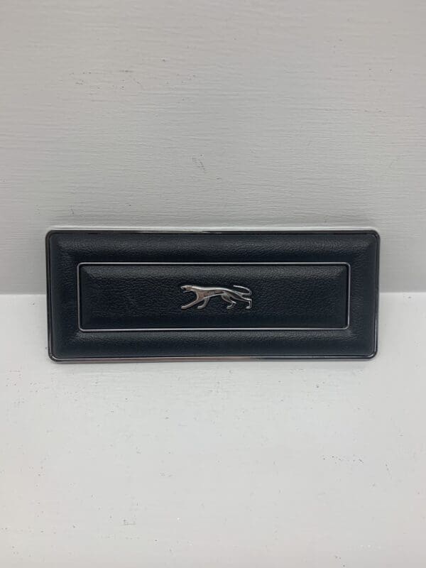 A black leather box with a silver lion on it.