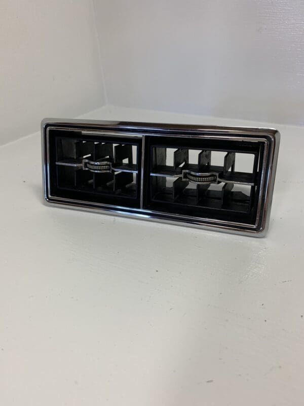 A black and chrome car radio on top of a white table.