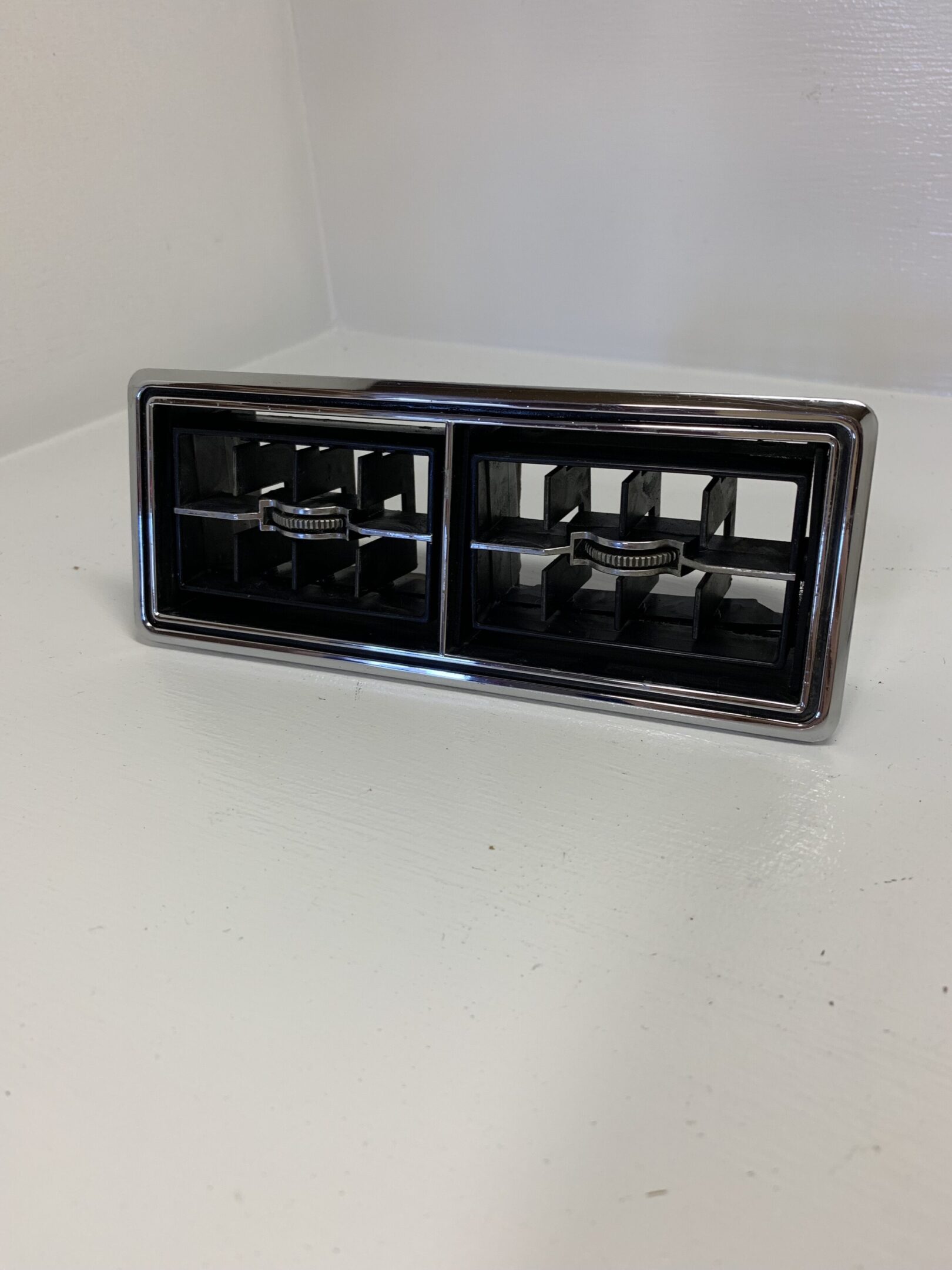 A black and chrome car radio on top of a white table.