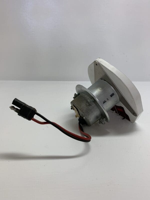 A white electric motor sitting on top of a table.