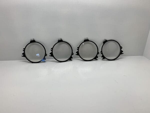 A group of four round black metal frames.