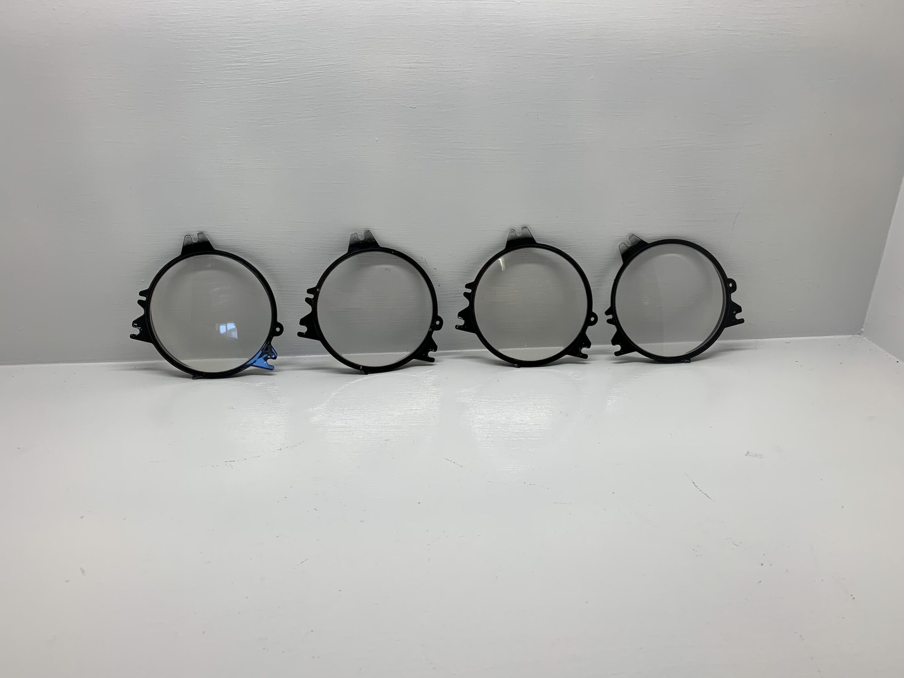 A group of four round black metal frames.