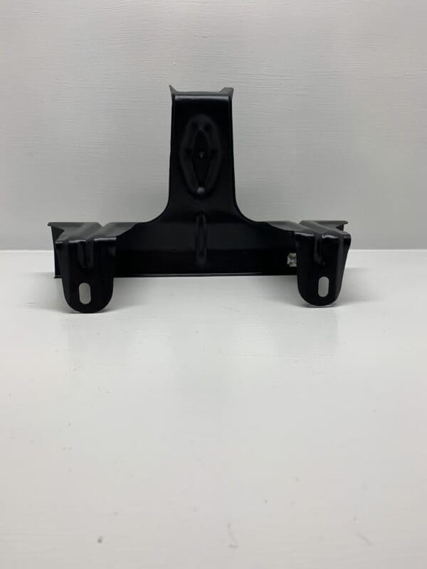 A black plastic object sitting on top of a white table.