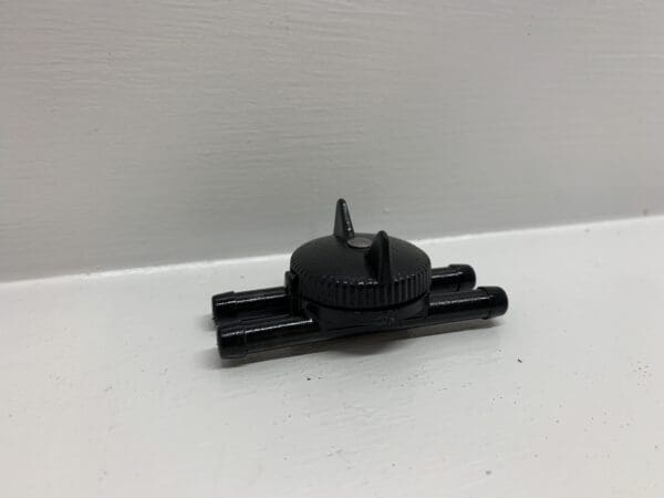 A black plastic object sitting on top of a table.