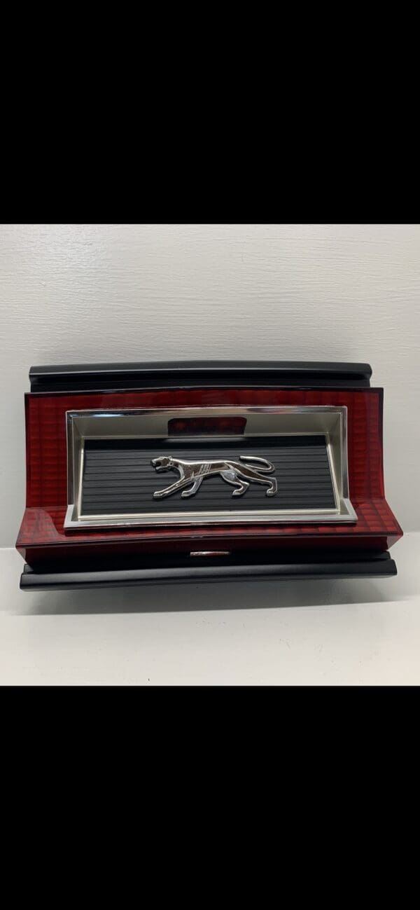 A red and black box with a silver dog on it.