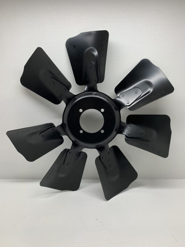 A black fan blade is shown on the floor.