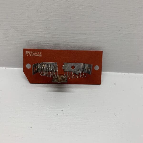 A red piece of electronic equipment on top of a wall.