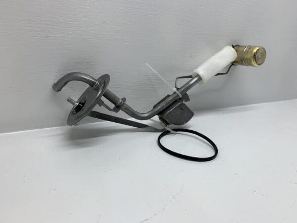 A white hose connected to an iron object.